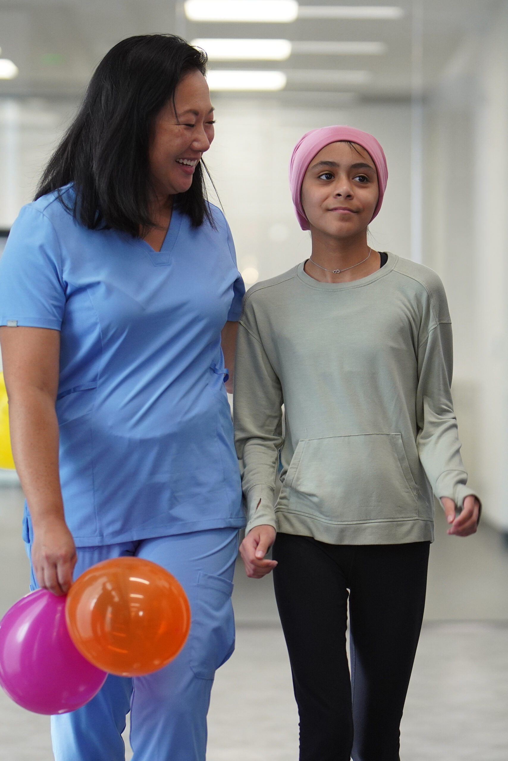 Nurse with patient Nurse walking with young girl who is going home after treatment